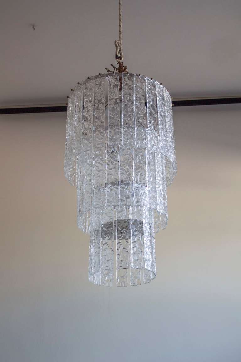 Amazing Murano Chandelier in excellent condition with transparent elements, circa 1970's. Having a height of 36 inches, and a diameter of 22 inches. The chandelier having an eight Italian light bulbs. We can professionally rewire this item to your