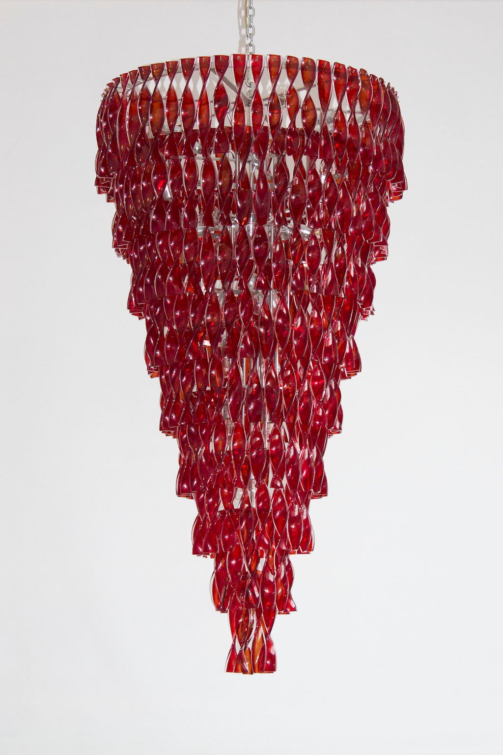 Beautiful red chandeliers in excellent original condition, composed by glass elements in red color in twisted form, with a chrome frame, circa 1970s. The chandelier is 71 inches high, by 40 inches diameter and having 32 lights.

We can