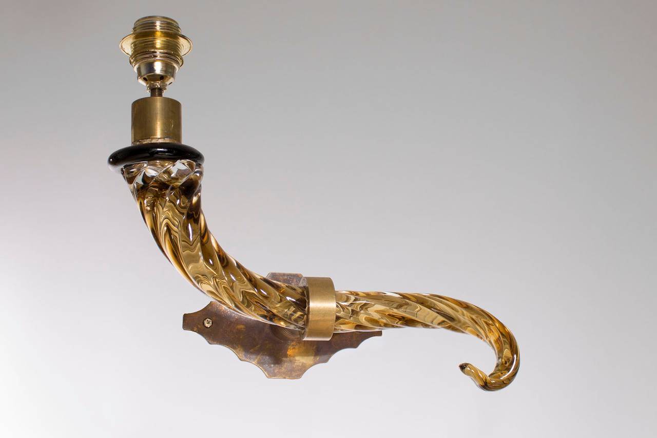 Italian Venetian sconces, in blown Murano glass, amber and brass, 1950s.
Five amazing Italian sconces, composed of a beautiful glass amber arm, supported by an elegant brass frame, entirely handcrafted in the Venetian Murano Island, by