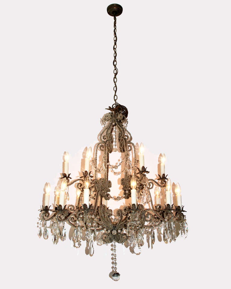 Two tier, 18 light Italian chandelier.  Tole and iron frame with beaded arms and crystal drops.