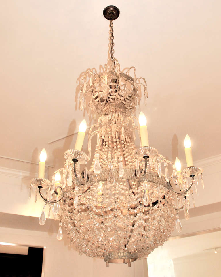 Tole and iron beaded crystal chandelier.  This eight light chandelier has a rich patina consistent with its age. Circa 1850.