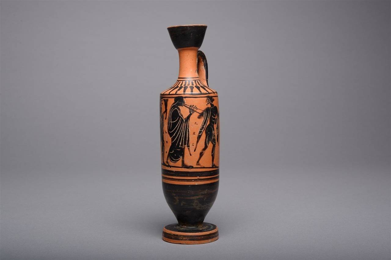 An ancient Greek Attic black-figure lekythos, dating to circa 490 BC.

A joyous scene decorates the body of this elegant black-figure lekythos (oil flask). We see a procession, perhaps Dionysiac in nature, with a male figure leading the way,