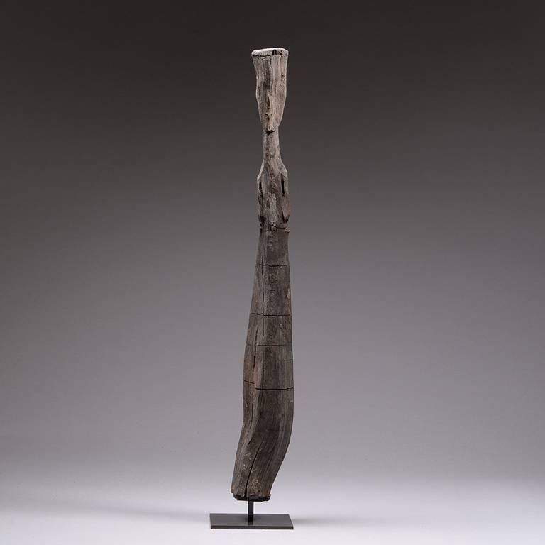 There is something truly elemental about this Chu kingdom figure, rather than being crafted from wood, it appears as part of the wood itself, with the human form only subtly emerging from the twists and fissures of the organic material.

Figures