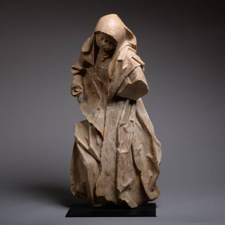 A carved alabaster figure of a Franciscan Nun, from Antwerp and dating to 1480 – 1520 AD.

This stunning piece is a reflection of late medieval sculpture at its finest, the work of a master in the full command of his medium. Clearly influenced by