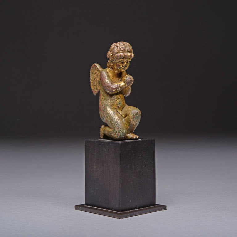 A stunning Northern European Renaissance period winged Putto, dating to the 15th-16th Century.

In this beautiful, tender scene, the small childlike figure is shown nude, kneeling in a sign of penitence, his hands clasped softly together in