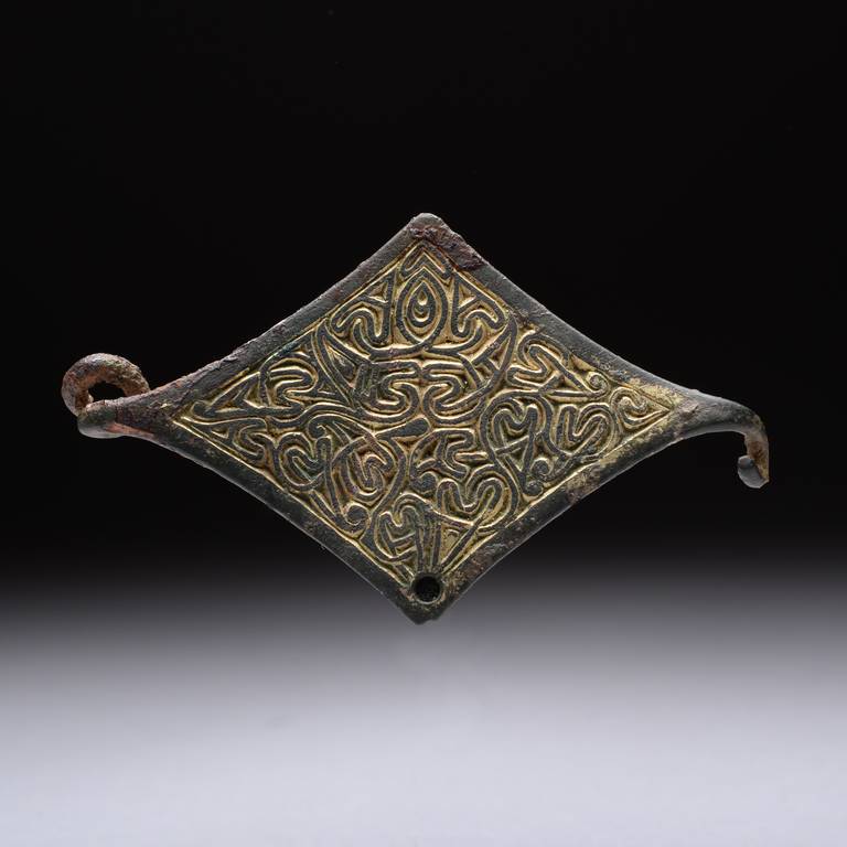 An early medieval Anglo-Saxon gilt bronze Arabesque style strip brooch, dating to around 550 – 650 AD.

An artifact of great significance, this wonderful bronze brooch may be completely unique. With restless chip carved patterning, its gleaming