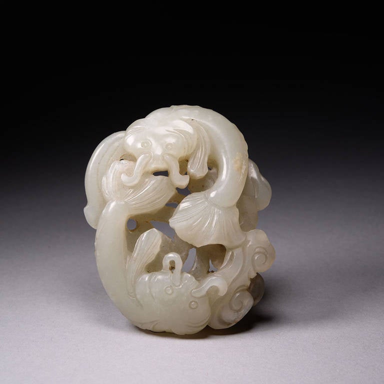 A beautiful Antique Chinese celadon jade carving of two catfish or nian, sat on a bed of mushroom (lingzhi) sprigs, dating to the Qing dynasty, 18th to 19th century.

Exceptionally well carved in openwork technique from a pebble of beautiful