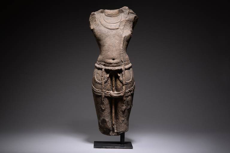 A fine medieval central Indian sandstone figure of a standing male god, possibly Vishnu, dating to the 11th century AD.

The god is shown standing upright, almost arching back.  He wears elaborate necklaces and his tightly fitting dhoti is adorned