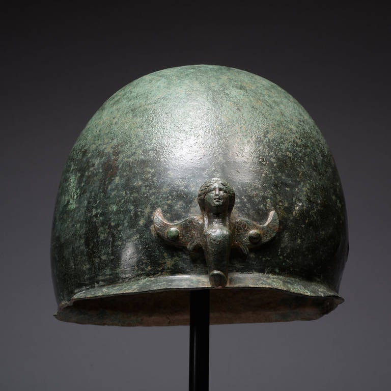 This exceptional Roman helmet dates from the mid to late 1st century BC. Adorned with rare cast decoration, it is the finest example of the ‘Mannheim’ type currently on the private market.

Exhibiting a beautiful deep green patina, this stunning