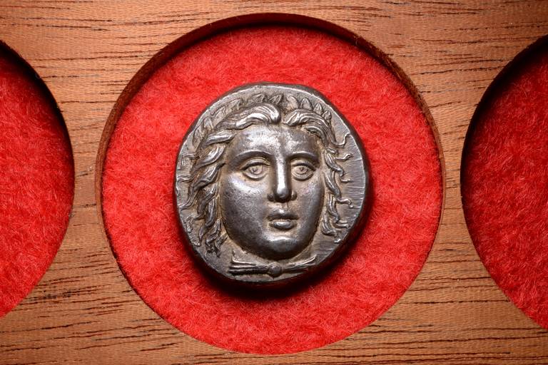 A superb, three dimensional ancient silver tetradrachm minted under the Satrap of Caria, Hidrieus. Struck at Halicarnassus, western Asia Minor, circa 351 - 344 BC.

The obverse with a superb three-quarter facing portrait of the god Apollo. The
