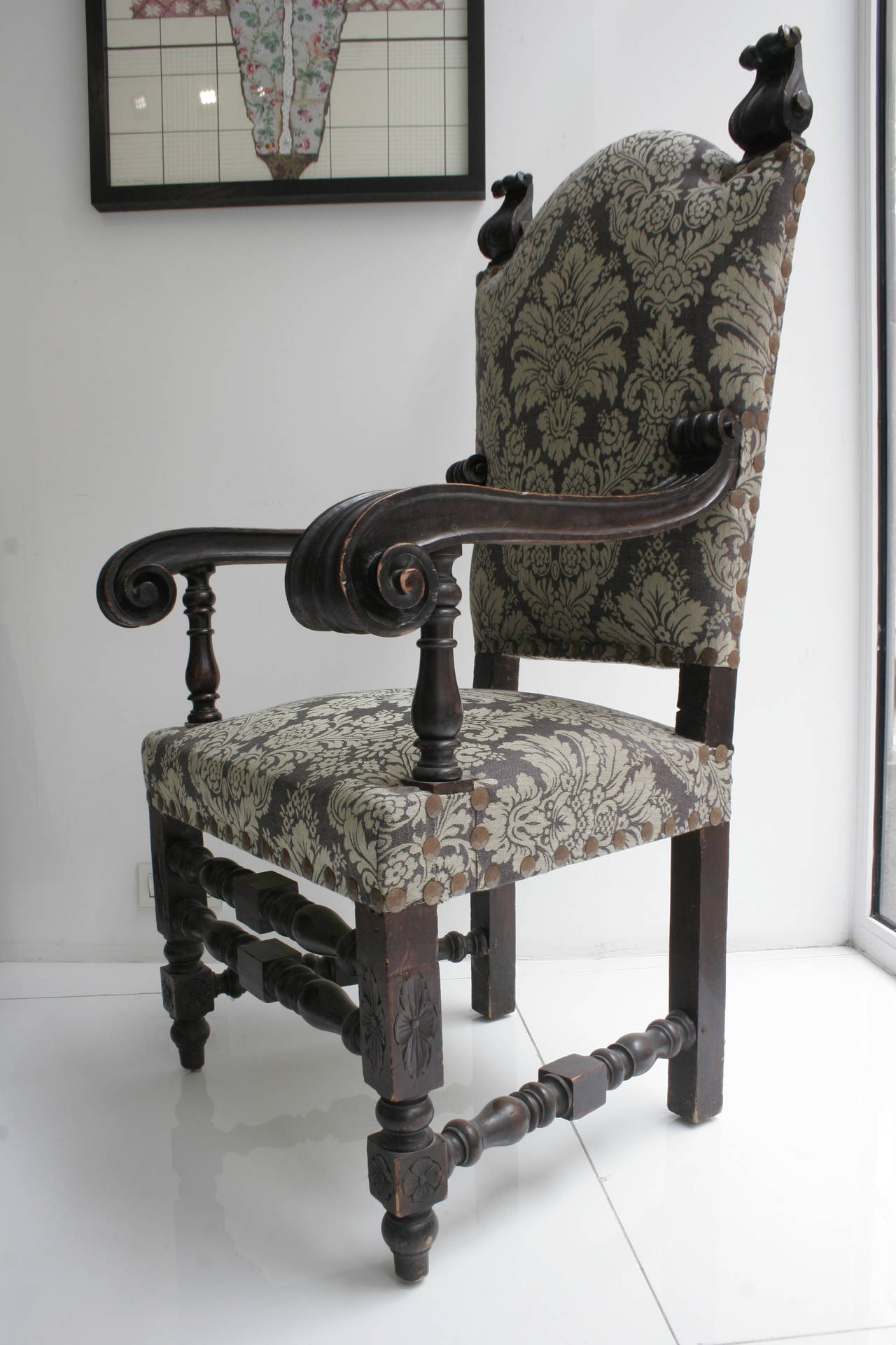 Pair of towering wooden armchairs blackened seats and seat covered with gray damask. Probably Spanish or Italian Baroque furniture, 19th century.