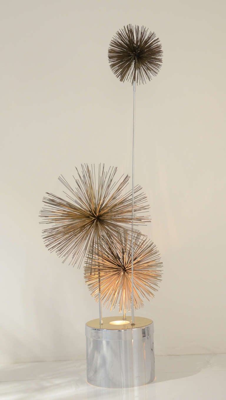 A metal pom pom floor lamp.