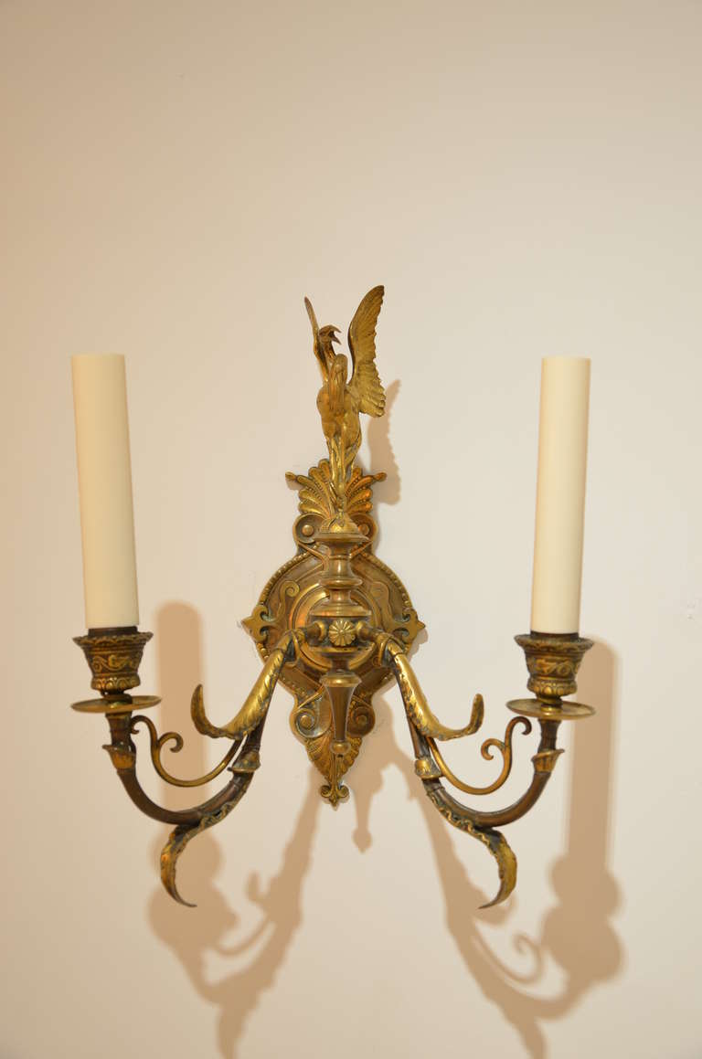 Pair of sconces featuring a heron with outstretched wings signed by Ferdinand Barbedienne.