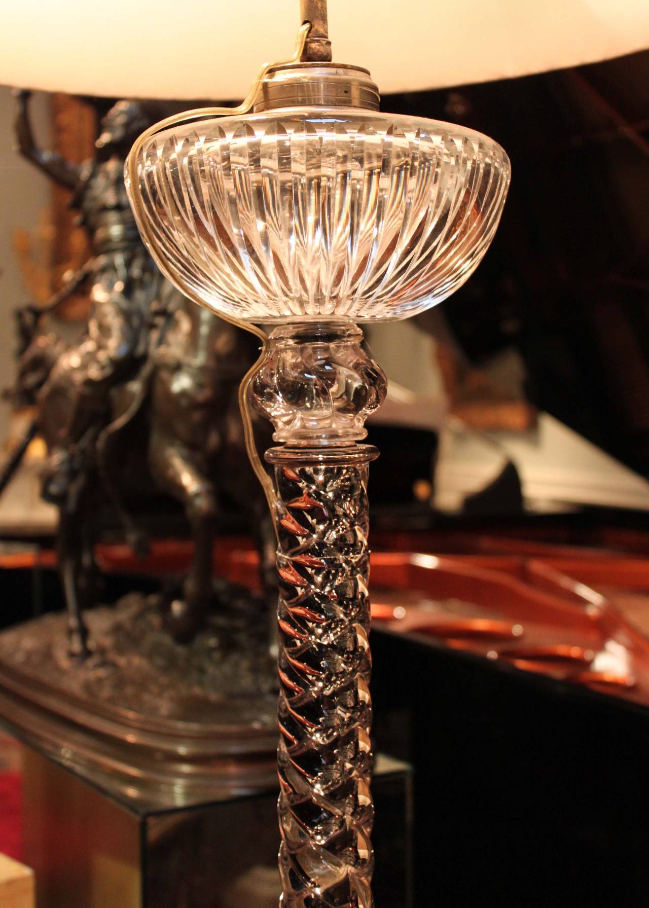 Original matched pair of Baccarat oil lamps converted to electricity. Rope-twist motif complete with cut crystal reservoir and square base. Exterior wire, two-bulb socket with dual pull chains, sold with box pleated silk shades.