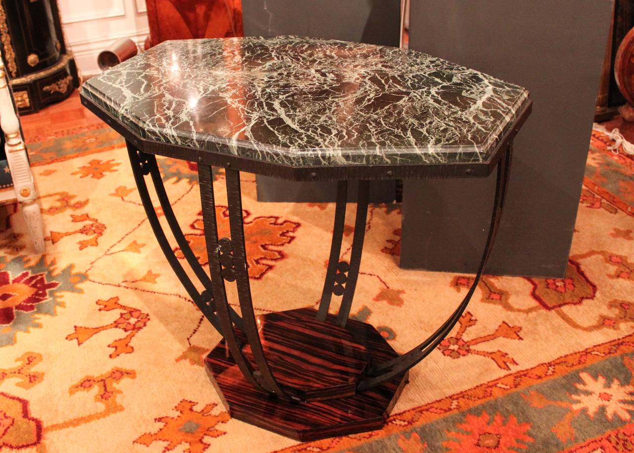 Pair of Art Deco occasional tables with geometric marble top supported by four curved wrought iron legs with circle detail. Rosewood base, lacquered and original.