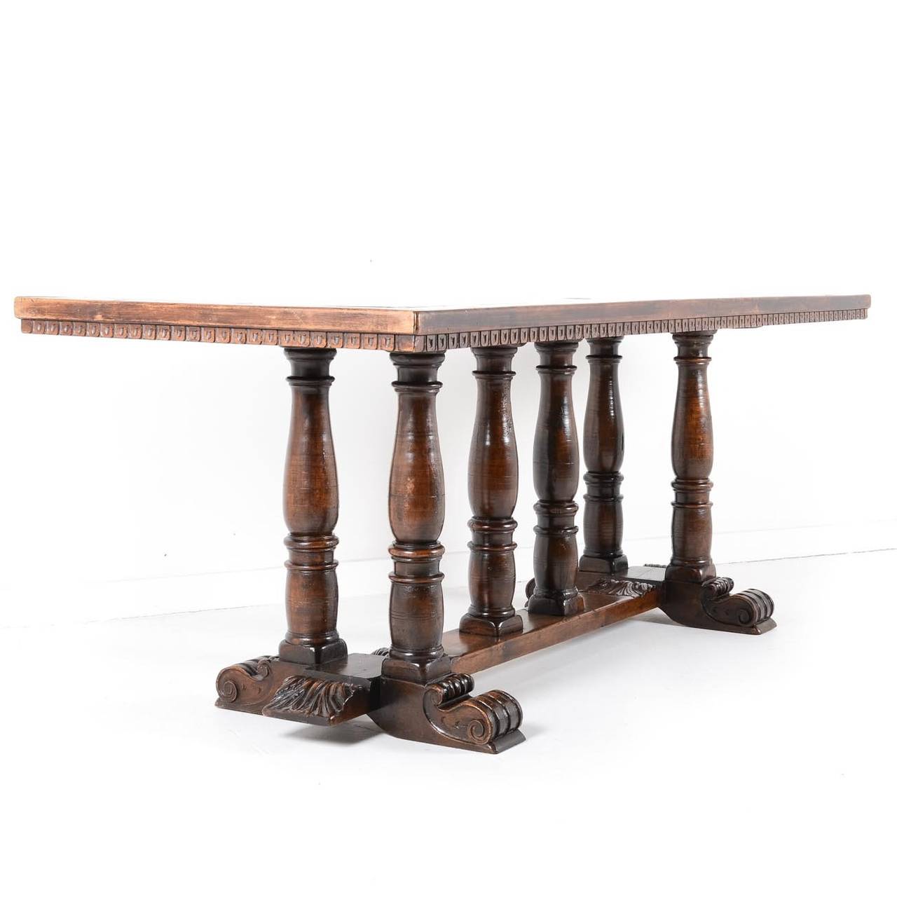 Antique French trestle farm table with six turned legs on carved base. Wonderfully detailed, great patina consistent with age and use. Note the small bow typical of a table of this era.