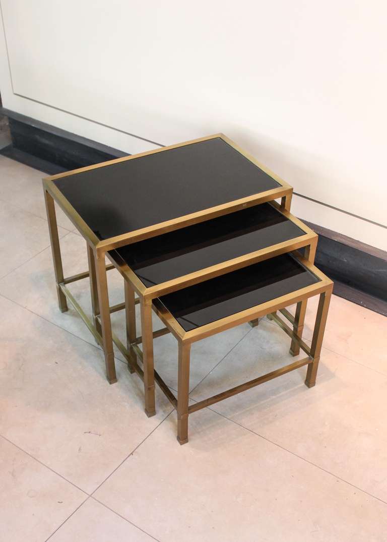 Ca. 1950

Set of three bronze nesting tables with deep black glass. Original finish and natural patina.

Largest Table: 18.5