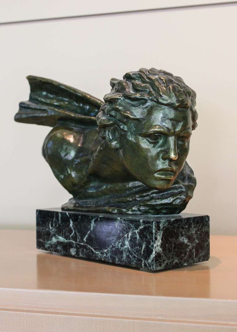 Circa 1930 

Art Deco bust of a young male looking over his left shoulder with an elongated neck by Alexander Kéléty. Bronze with green patina on marble base. Stunning quality, composition and condition. Signed.

Alexander Kéléty studied