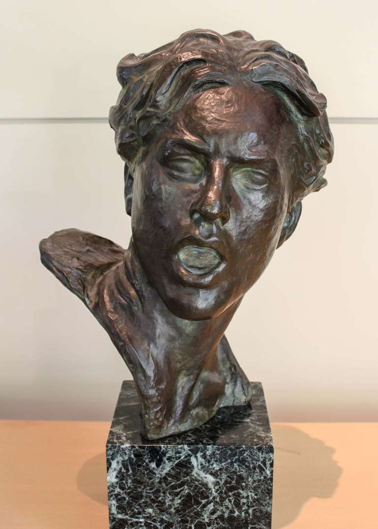 A large-scale bust of a young male by Alexander Kéléty, looking over his shoulder with an open mouth. Green patina, bronze on a marble base. Signed with foundry seal.

circa 1930s.

Born in Budapest, the center of arts and culture at the time,