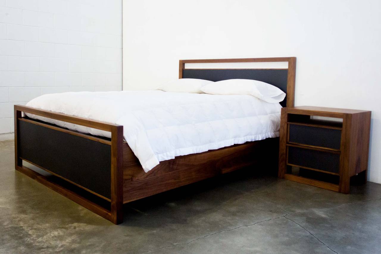 Bed from the Parallel Collection by Vancouver, B.C. designer Kate Duncan. Horizontal planes of walnut are accentuated by inlays of black leather and finished in a deep chestnut hue. The Parallel Collection highlights the exquisite joinery techniques