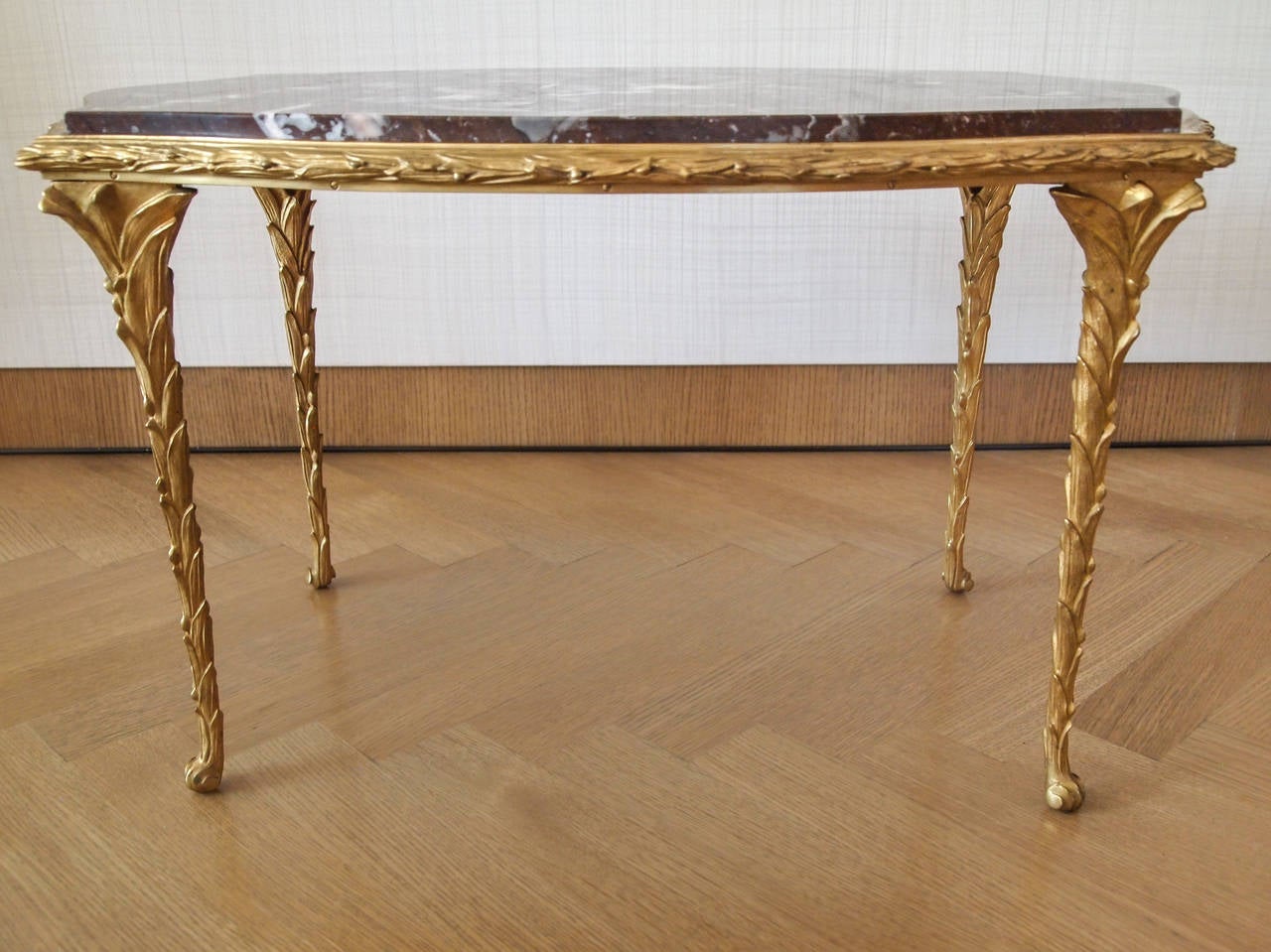 Beautiful gilt bronze side table with marble top by Maison Baguès. Fully decorated base with gilt foliate castings on almost every surface. Excellent condition with minor wear to gilding.