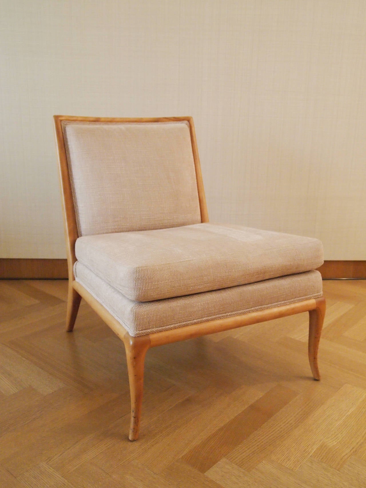 A rare settee and matching slipper chair by T.H. Robsjohn-Gibbings, manufactured by American maker Widdicomb Furniture Co. 

Neutral stone-coloured fabric over bleached mahogany, clean mid-century lines with a small cabriolet leg. The settee is an
