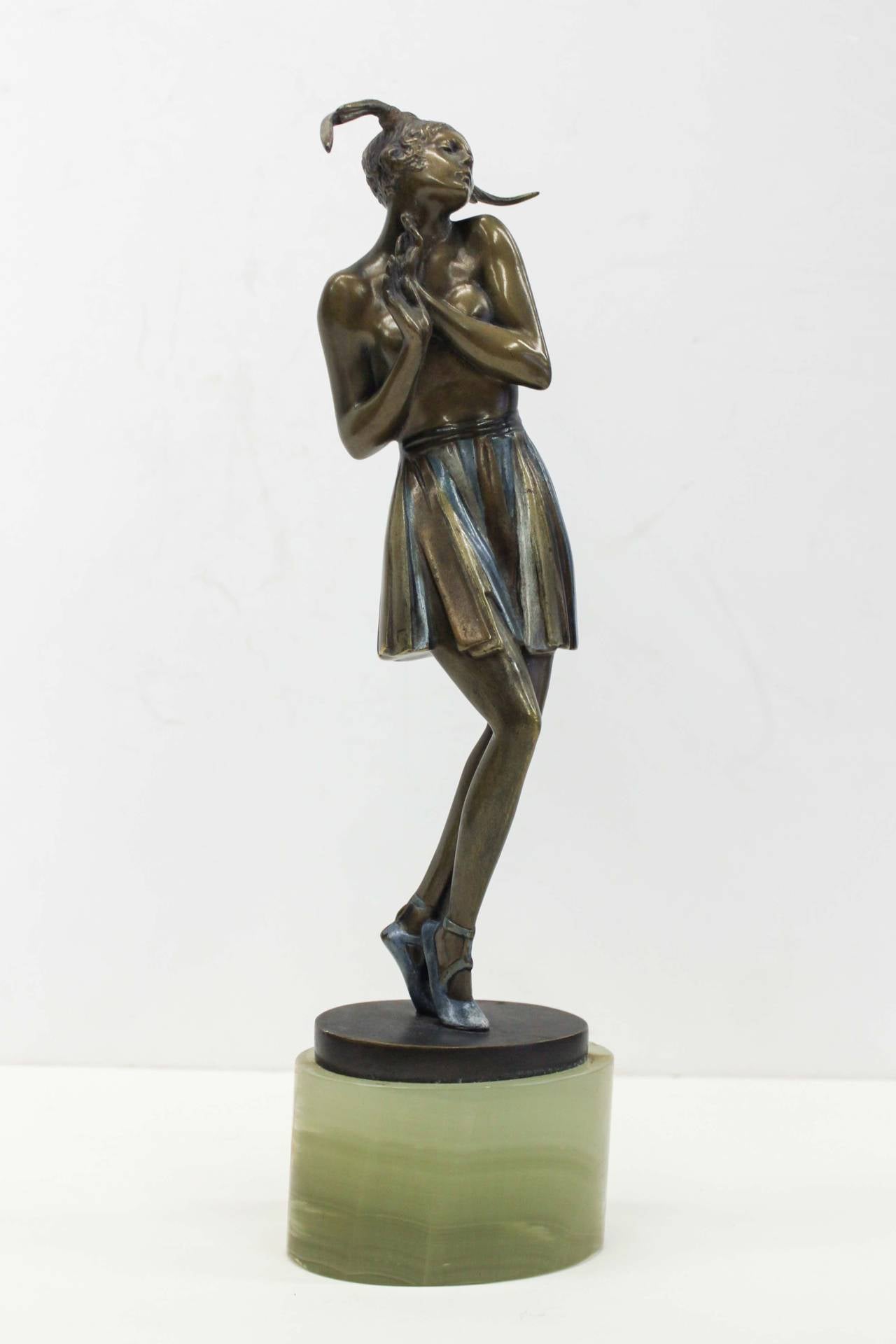 A beautifully rendered Art Deco bronze entitled 'Tanzendes Madchan' by Bruno Zach (1891-1945). Delicate and provocative, this piece portrays a dancer posing during a performance wearing only a skirt and head-piece. The subject was possibly inspired