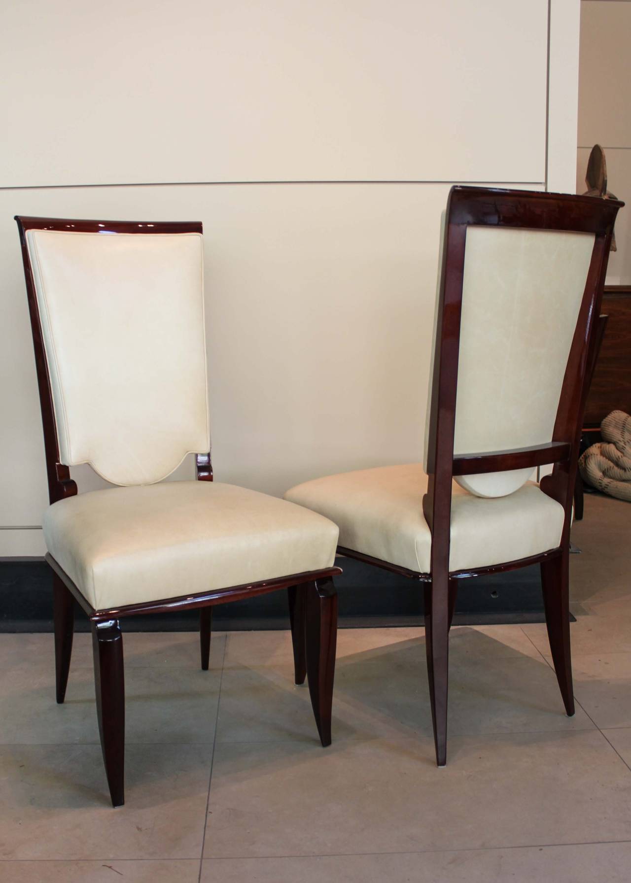 Set of six upholstered high back chairs covered in cream leather, restored and polished circa 2000.
