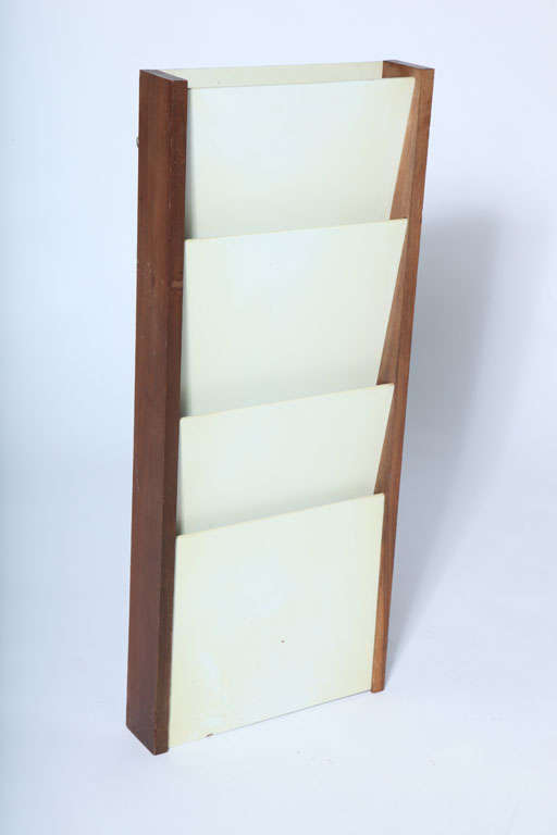 Wall mount magazine holder by Peter Pepper Products. Signed with metal label, USA, circa 1970.

Features a walnut wood frame with white laminate dividers. Some vintage wear.

Measures: 33 inches high x 14 inches wide x 3.5 inches D.