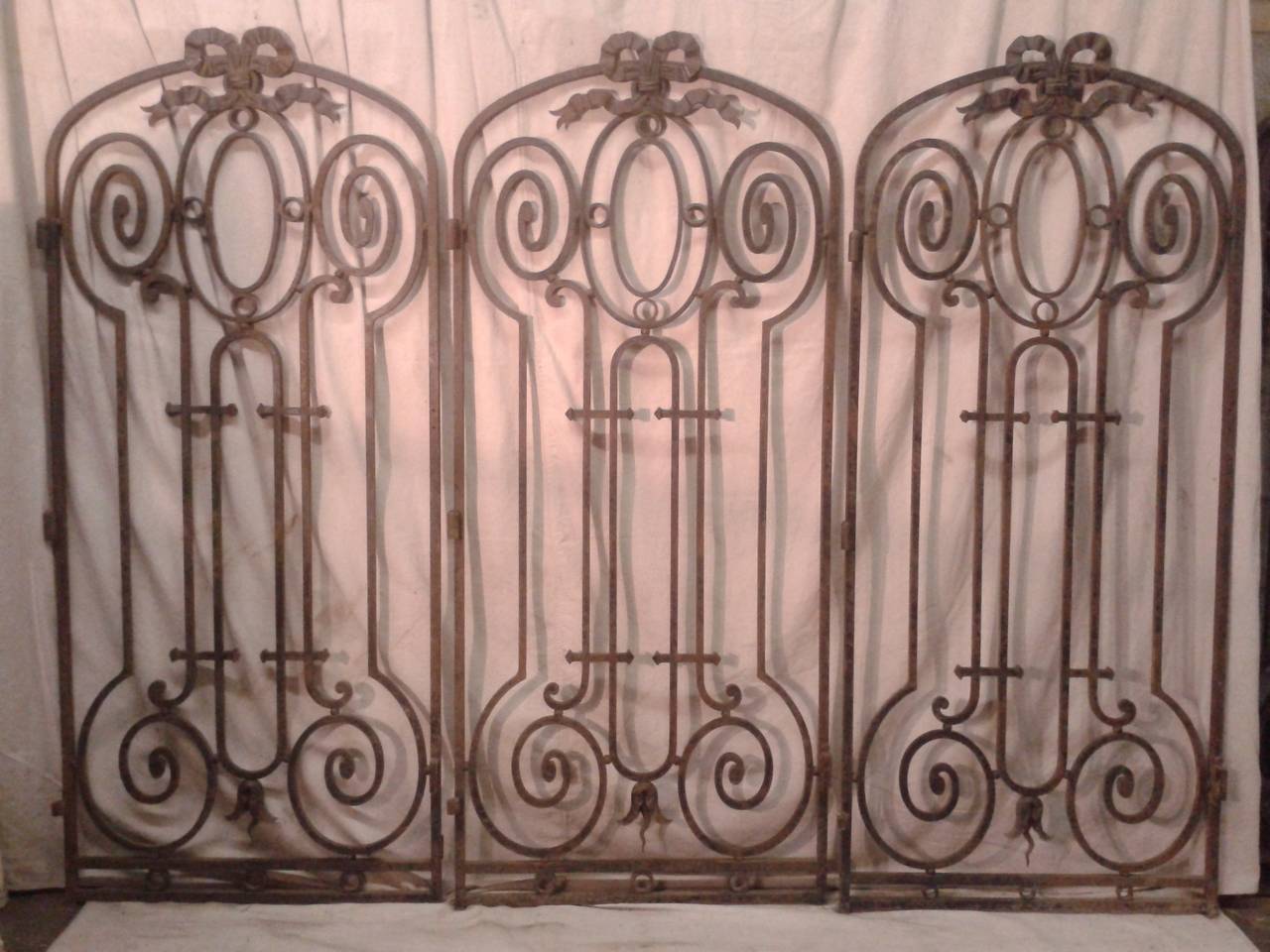 A full set of three pairs of 19th century French iron gates, Louis XVI style. A beautiful set one of a kind outside doors.