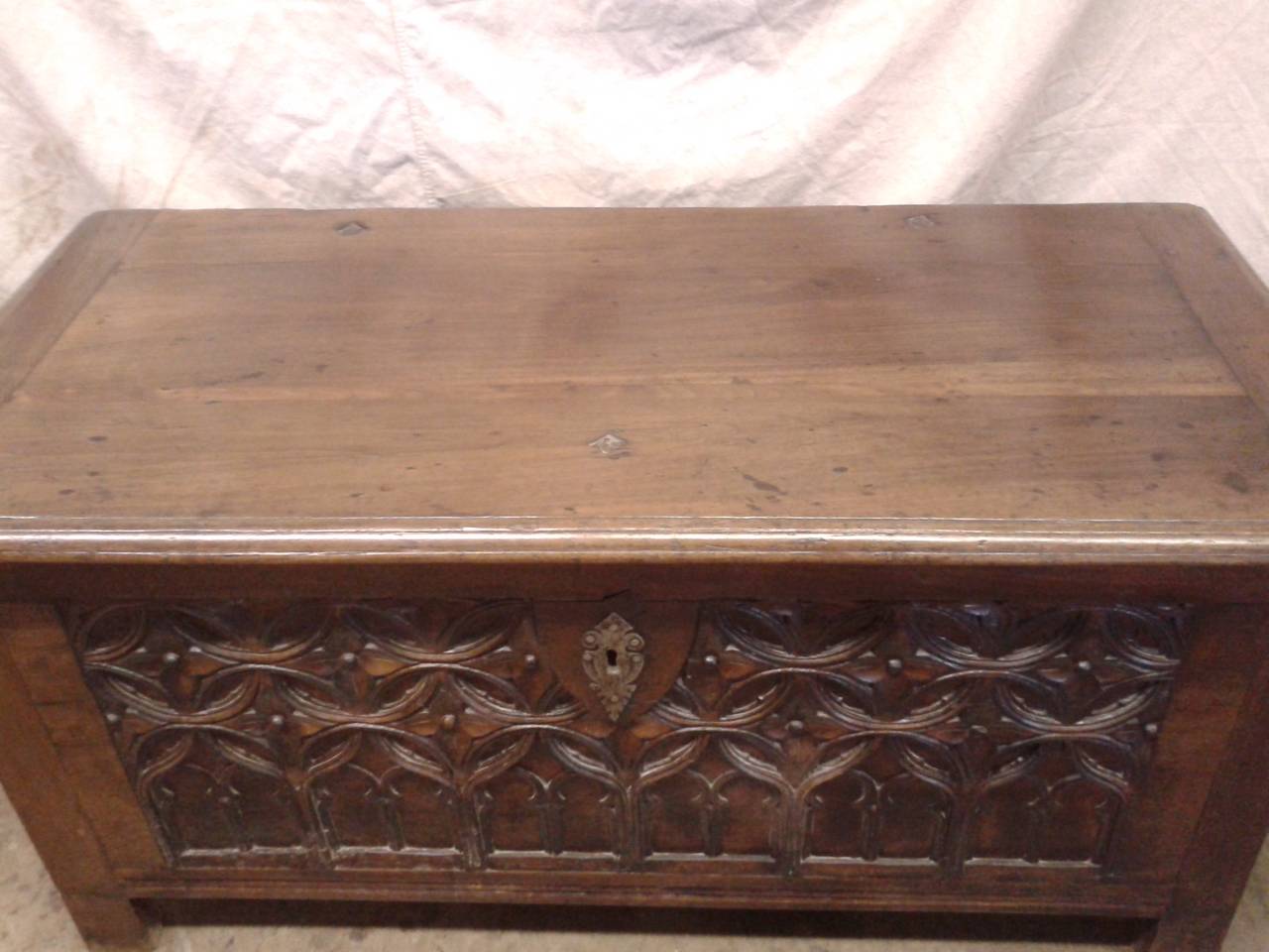 This is a beautiful 18th century, French, walnut trunk is delicately carved in the Gothic style. The trunk can be used as a storage furniture or a coffee table.