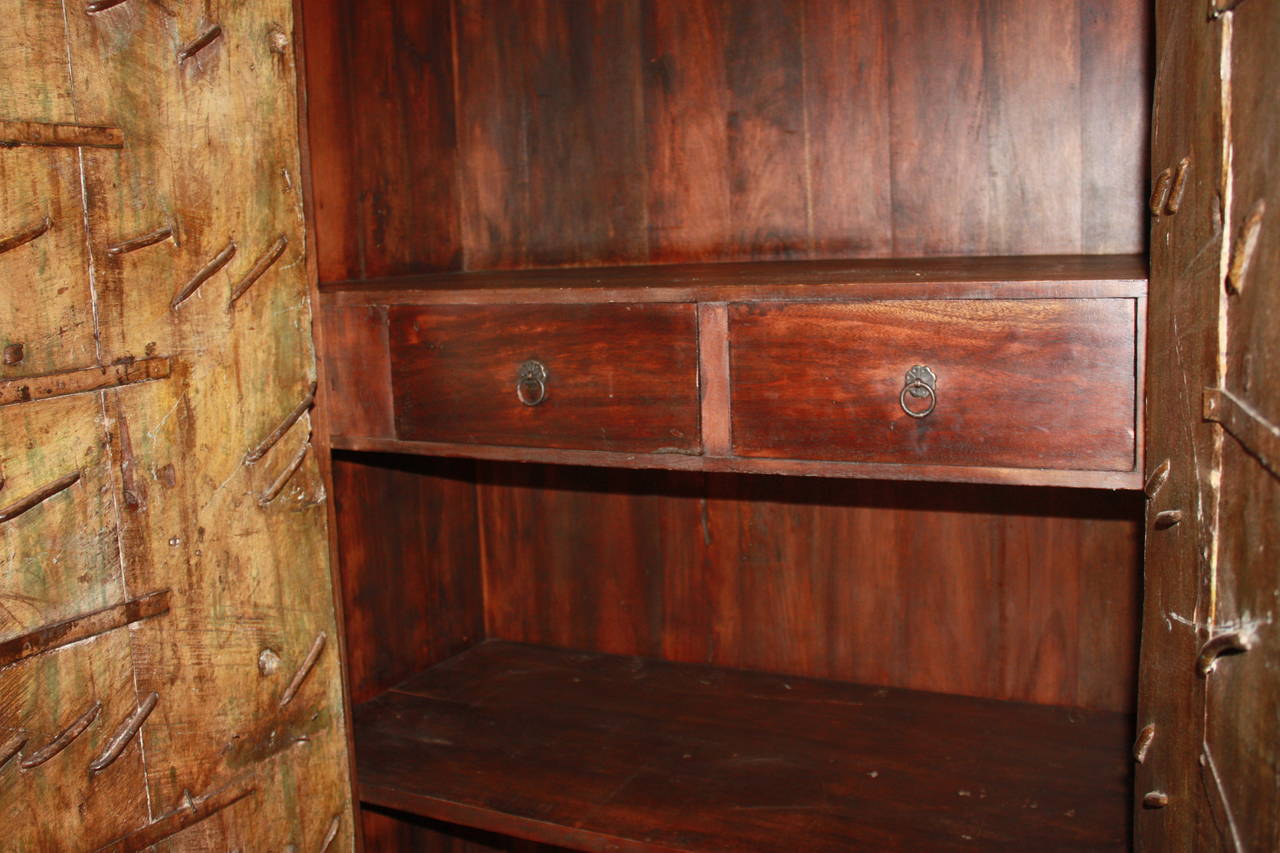 Early 20th century Indian wardrobe, painted oakwood covered with iron locks and chains.