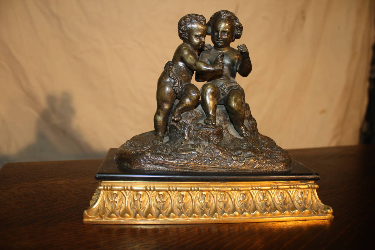 19th century French bronze sculpture representing two putties. The bronze is patenate and the base is in gilt bronze.