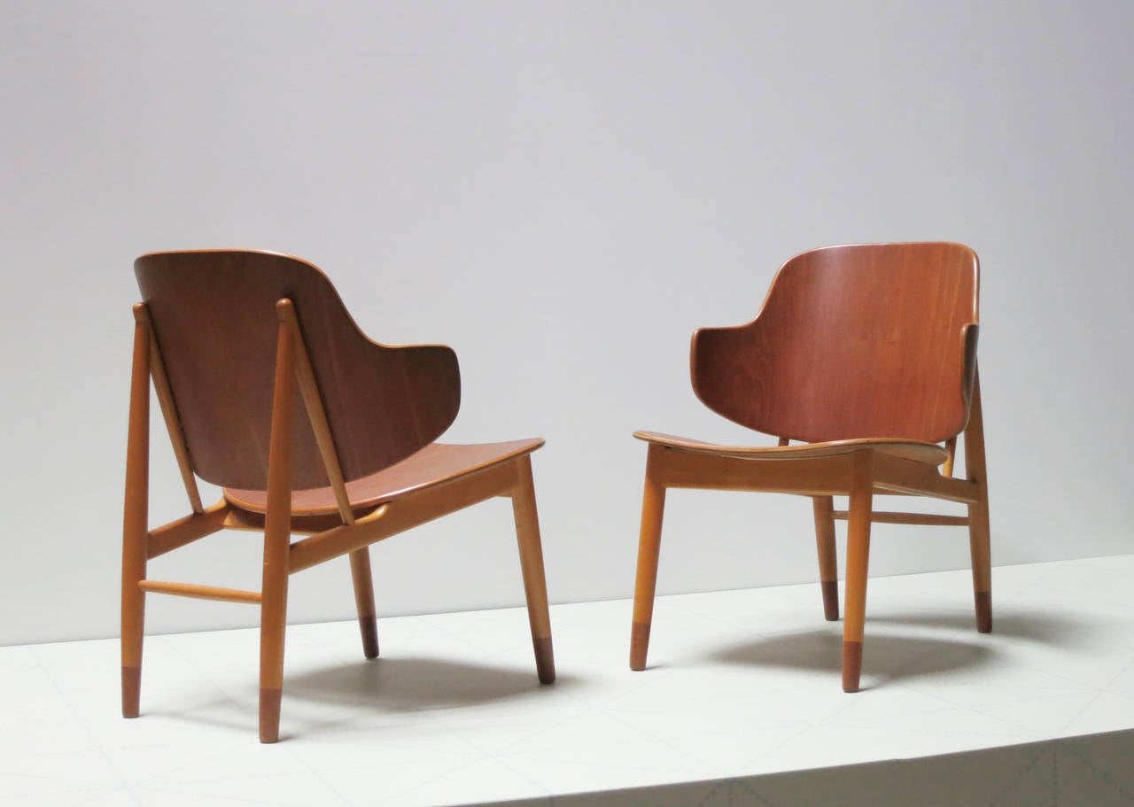 Ib Kofod-Larsen (1921-2003).

a pair of lounge chairs.

Designed 1950. This pair made 1950s.

Stamped on the underside: Made in Denmark.
Teak seats and feet, beech frames.

Literature
Grete Jalk, ed., 40 Years of Danish Furniture Design: