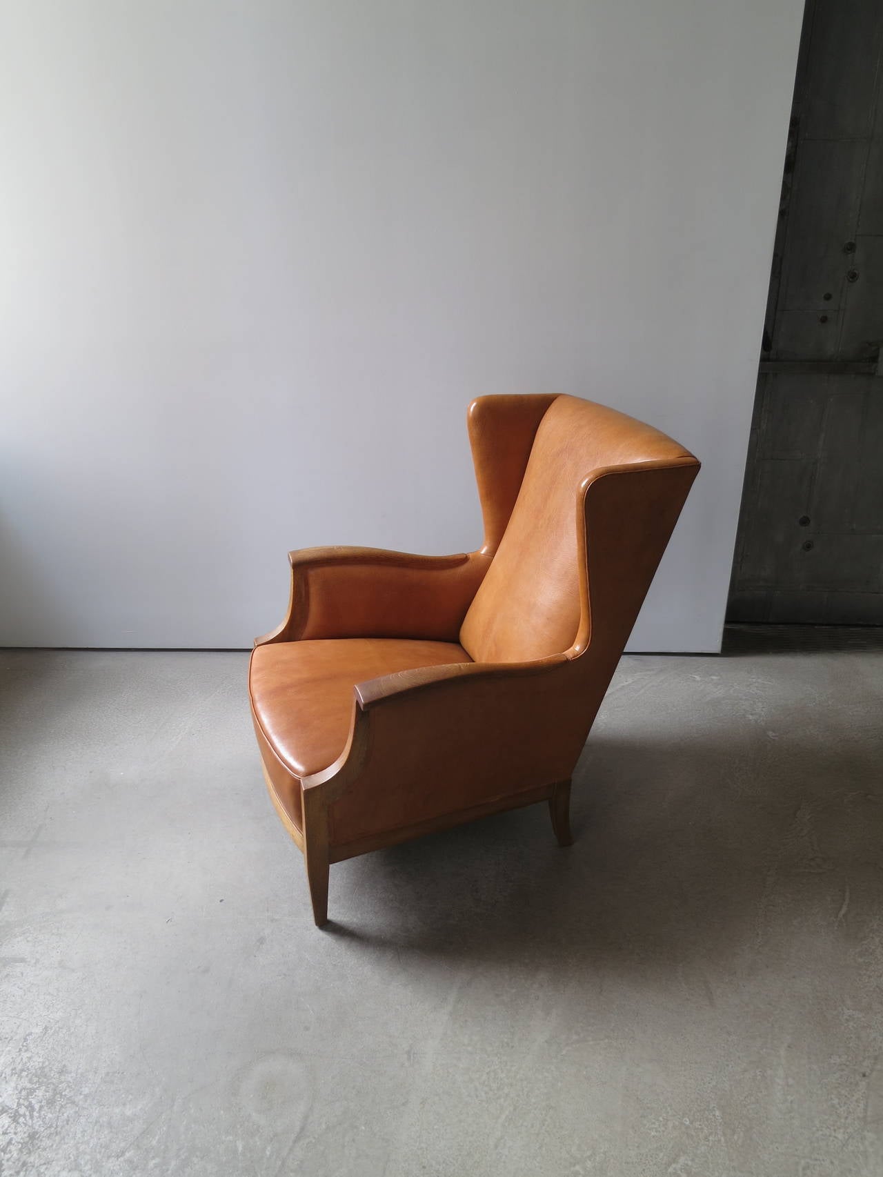This fully sprung, very comfortable wingback chair was designed and made by Frits Henningsen in the 1930s. The natural Nigerian goat hide and oak are one of Henningsen's more rustic combination of materials.