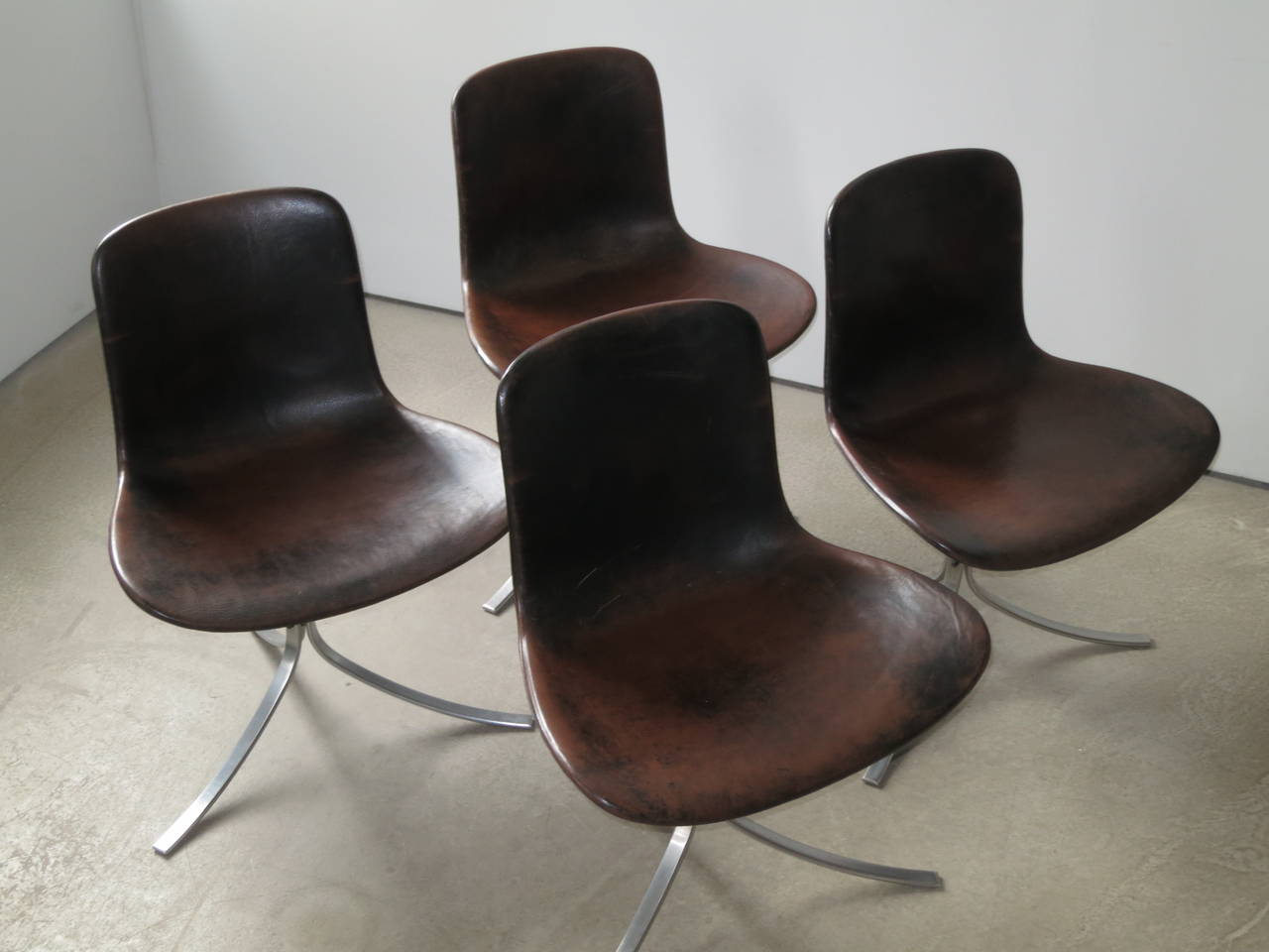 Designed in 1960 and considered one of Kjærholm's masterpieces, the leather seat and back of this chair sit on three beautifully curved steel legs in a way so as to appear to be floating. Its Minimalist design belies an incredible comfort, with