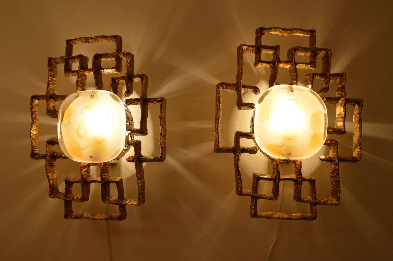 Pair of sconces in brass and glass designed by Angelo Brotto for Esperia edition called Fantasia luminosa. 
Circa 1970
Measures : 
H : 50cm 
L : 40cm 
D : 13cm 
Diameter of glass : 18cm