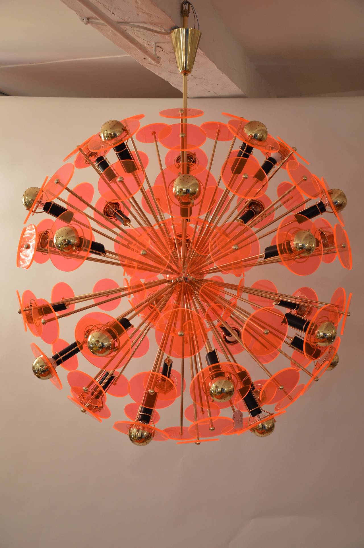 Important chandelier in gold varnished brass and orange plexiglass, designed by Fedele Papagni. 
Measures: 
Diameter  110cm.
Height: 140cm. 
Diameter of the big plexiglass disc: 15cm.
Diameter of the little plexiglass disc  13cm.