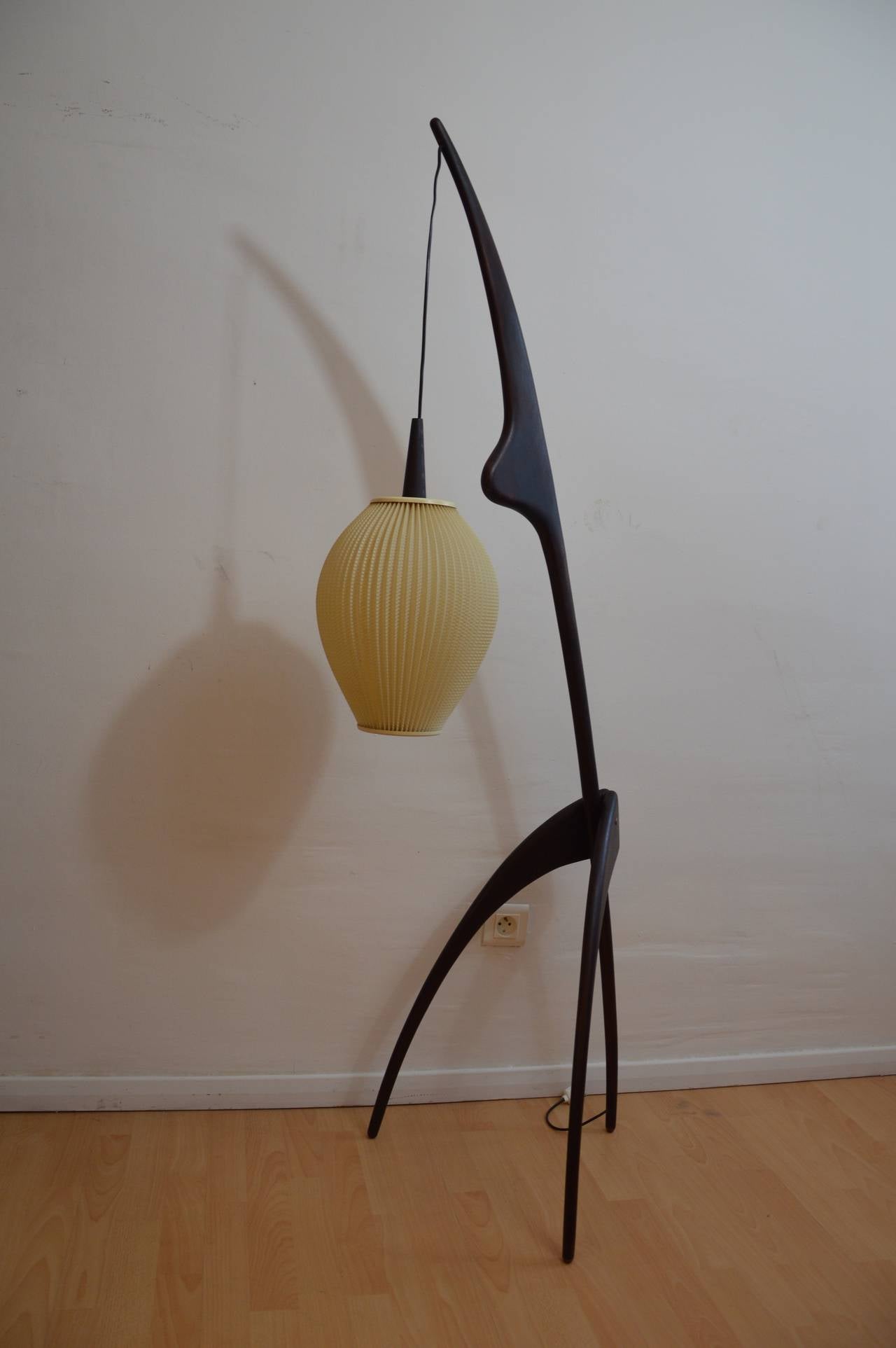 Floor lamp in massif dark teck wood with lampshade in plastic 