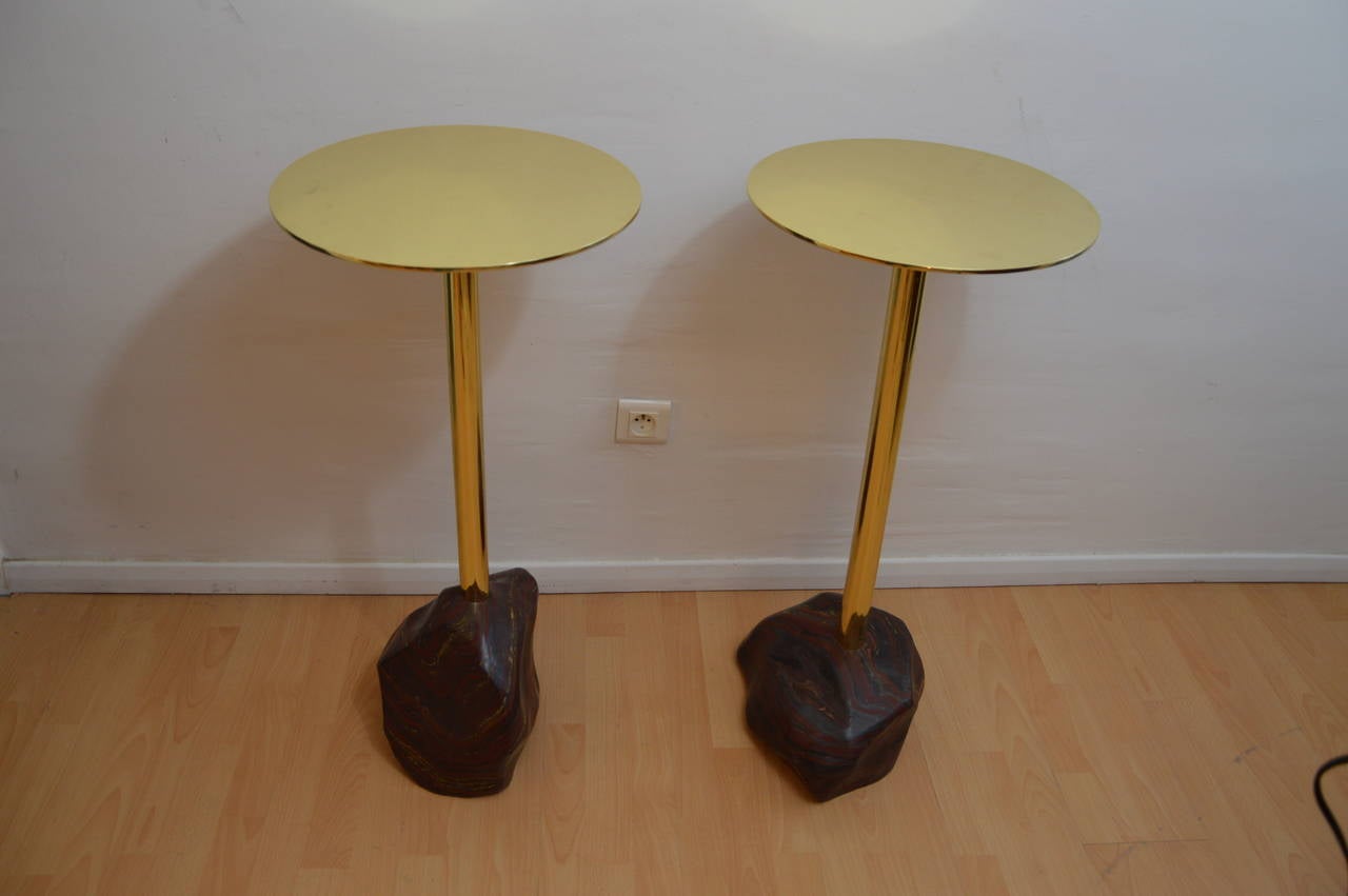 Pair of high pedestals tables or small bar tables in massive shine varnished brass with Iron Striped Stone from Madagascar sculpted by hand. Each piece is unique. 
Contemporary Italian production. 
Each pedestal table weighs between 20 and 25kg.