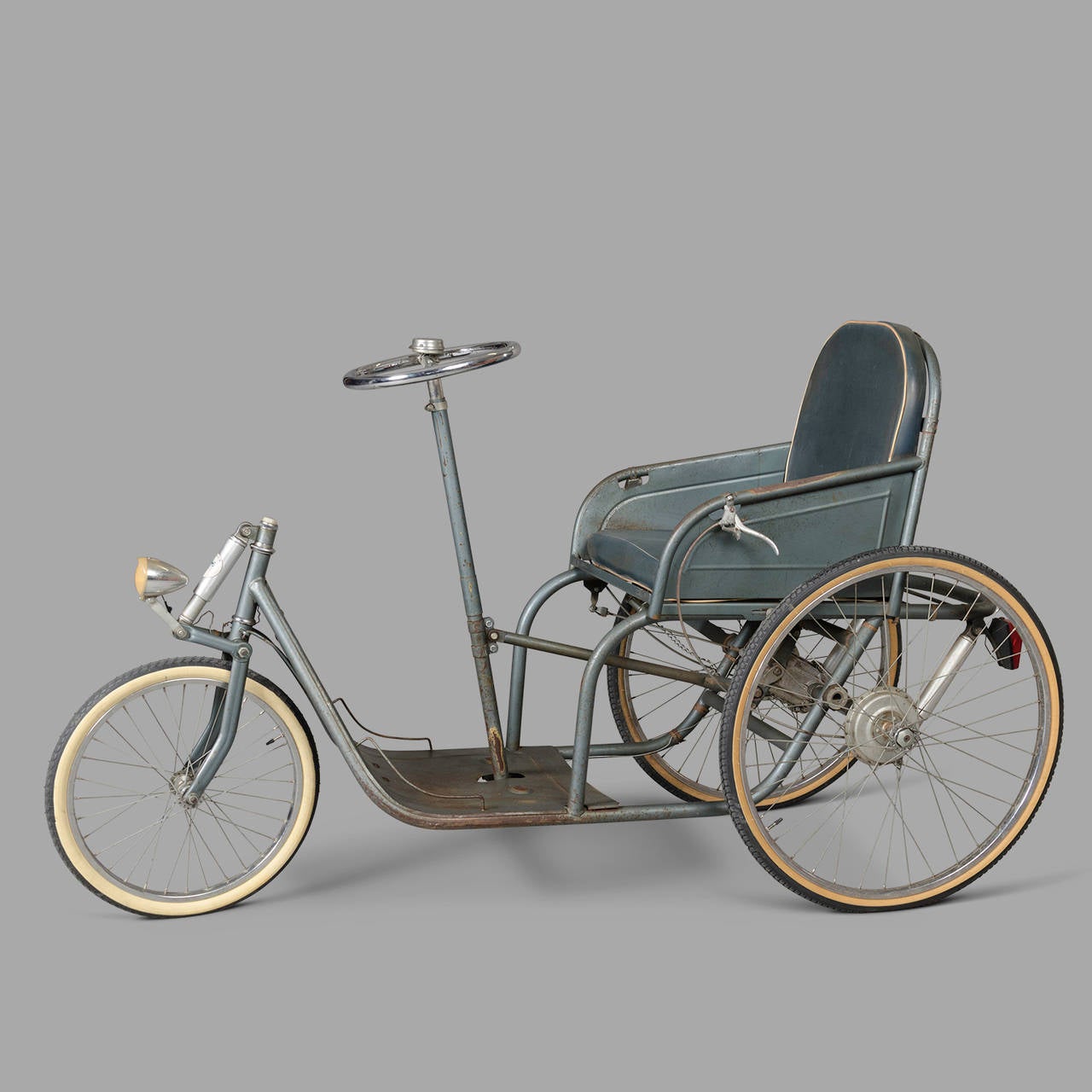 This antique wheelchair was manufactured in France by G. Poirier during the late 1920s. These were primarily used by injured WWI soldiers and people who suffered from polio.
Forward motion is obtained by pushing the steering wheel backwards and