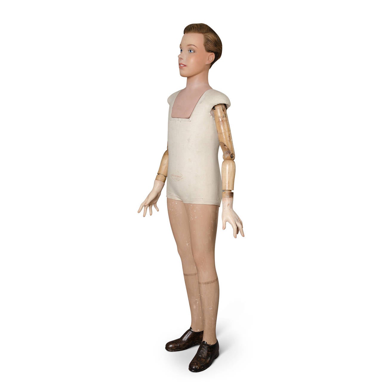 Child model mannequin signed Pierre Imans, Paris. Plaster head, legs and hands. Wood articulated arms. Natural implanted hairs. Glass eyes.