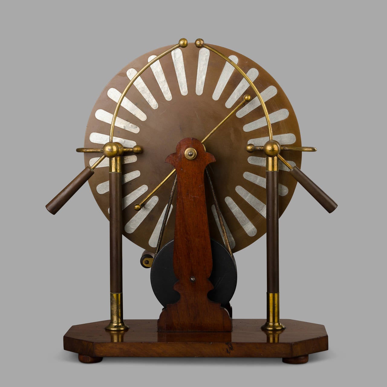 Mahogany model with brass elements.

The Wimshurst machine is an electrostatic device invented in 1882 by Englishman James Wimshurst.
This machine was historically used to illustrate many static phenomena or ozone production in an electric arc.