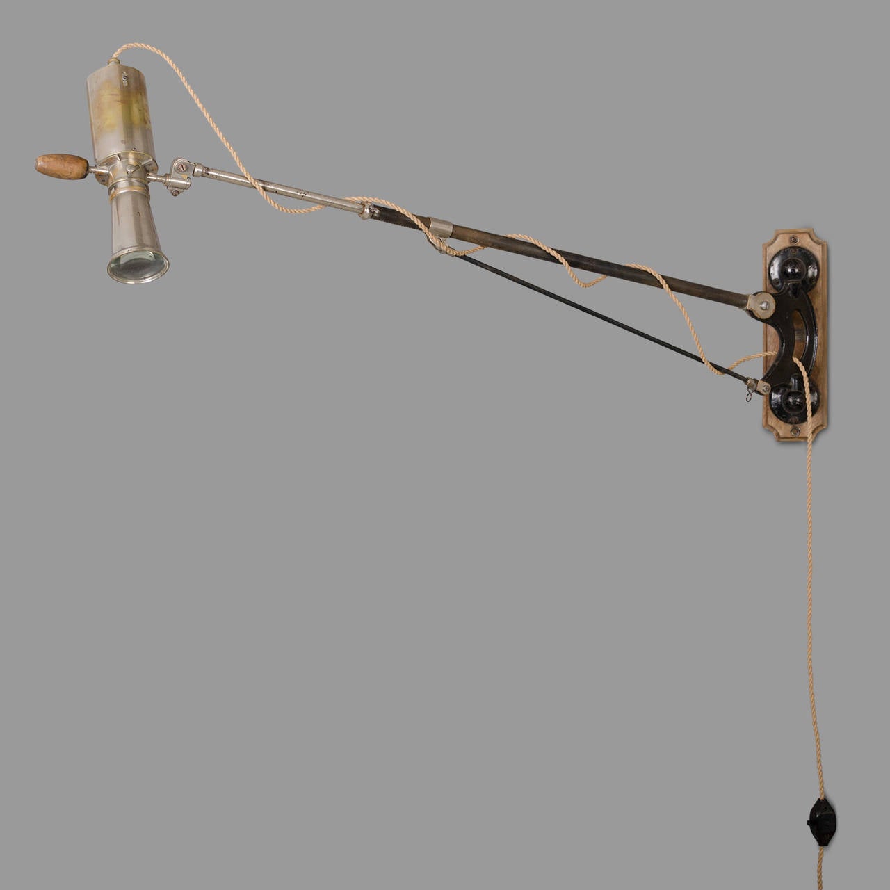 Nickel-plated steel and raw steel wall lamp. Wooden handle for manipulation. This Directional, telescopic and hinged lamp is equipped with a lens which allows the light concentration. Mounted on a wooden deck.

Label of the manufacturer: