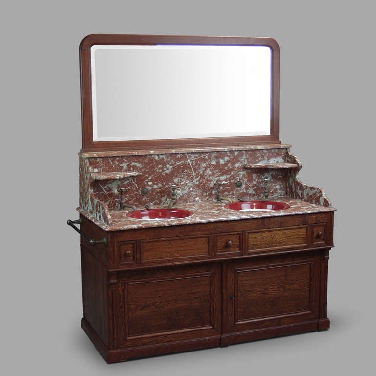Red Languedoc marble, pitch pine structure, two ceramic basins overhead. Original valves and mirror. Workplan height 84cm.