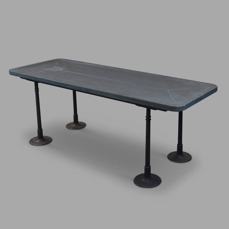 Slate table tope, wood and cast steel legs.