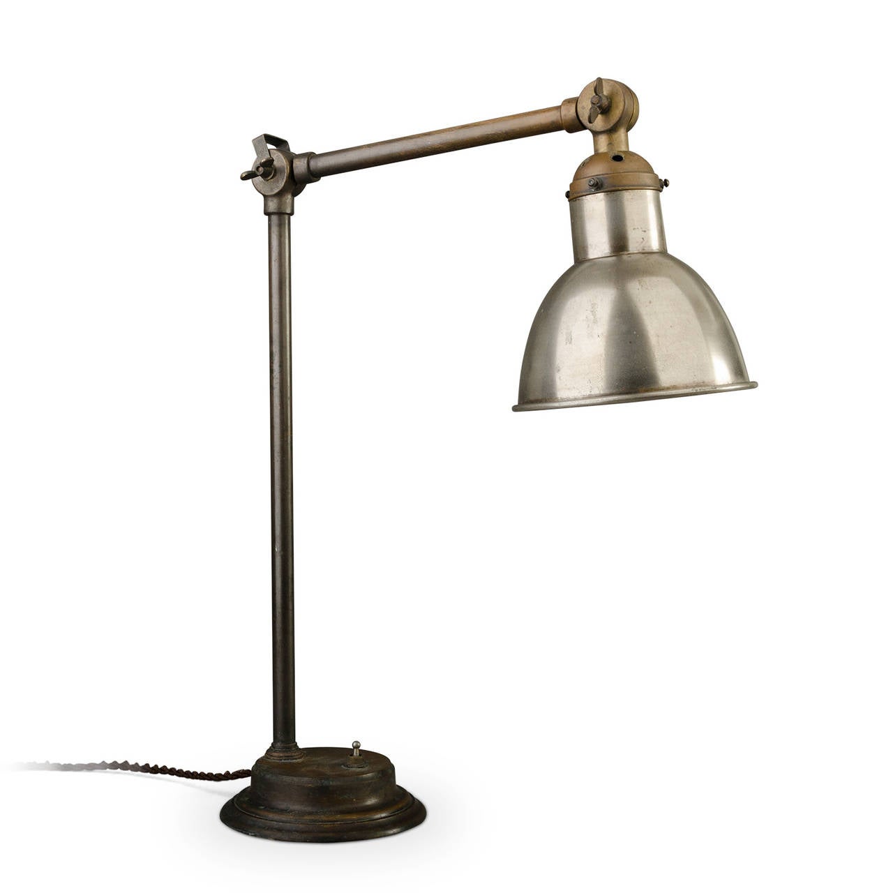 Very beautiful time patina for this articulated desk lamp. The ballasted base keep it quite stable. The reflector is in nickel-plated steel.