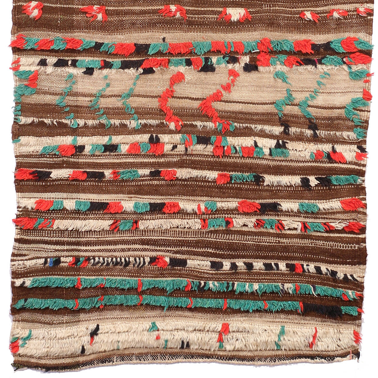 The background of this exciting textile is a soft kilim with many brown shades. Like a relief red, green, white and black knots are partially incorporated and built a lively and colorful surface.