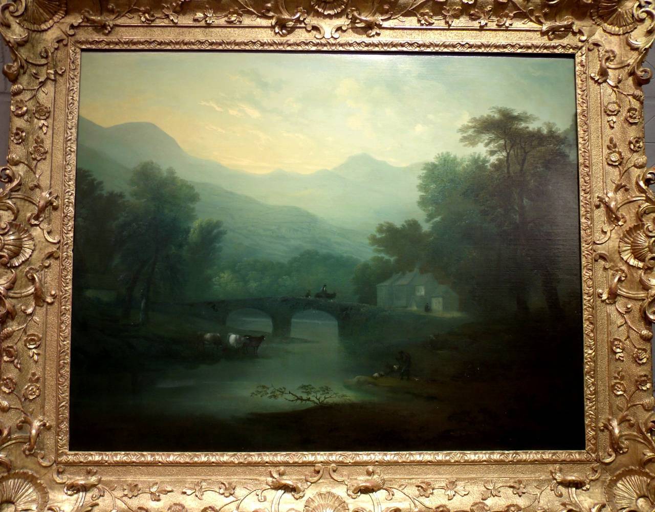 A superb late summer English landscape depicting a traveler returning home at dusk, encased by a hand carved giltwood frame of an extremely high quality. Both pieces date to the 18th century, circa 1780, the painting, a true country house picture
