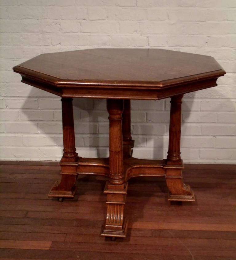 This very handsome solid oak octagonal shaped Centre table an X stretcher frame base with reeded square splay feet on moulding with brown porcelain castors. The table measures 36 in – 91.5 cm in diameter with a height of 30 in – 76.2 cm.